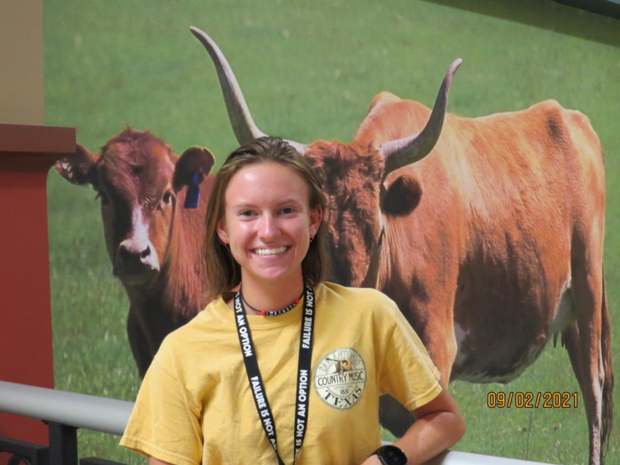 Kylie Marteney is all smiles in front of the longhorns.