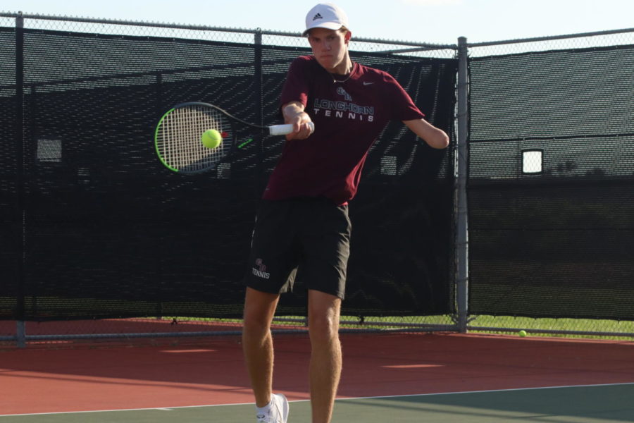 Clay Watson (10) hits a forehand back to his opponent. 