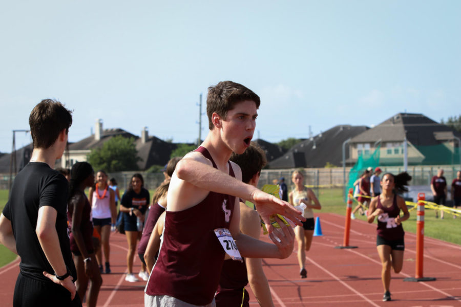 Ethan Macdonel (11) was cheering on his teammates as they finished.