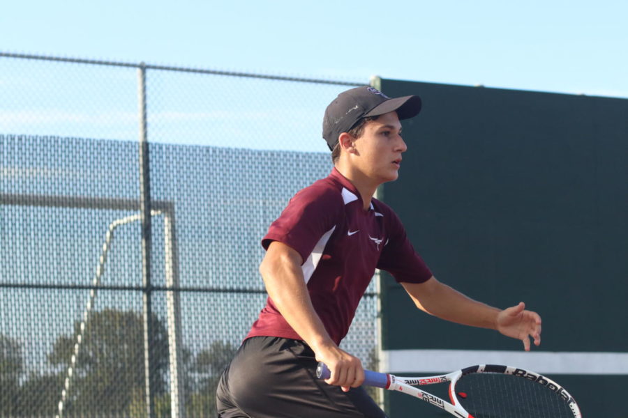 Michael Pearson (11) rushing to the middle of the net after hitting an overhead shot.