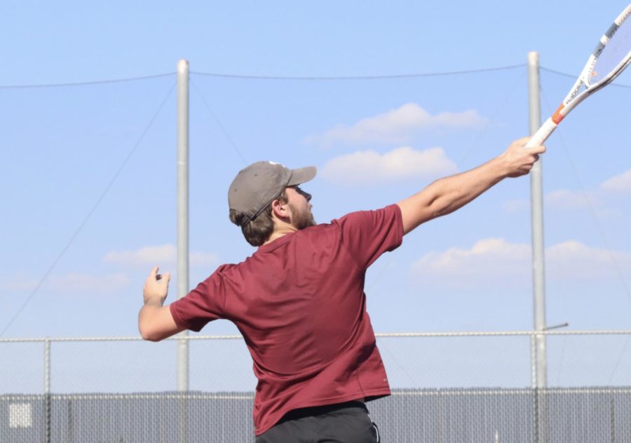 Judd Roth (11) hitting a winner volley in his mixed doubles match.