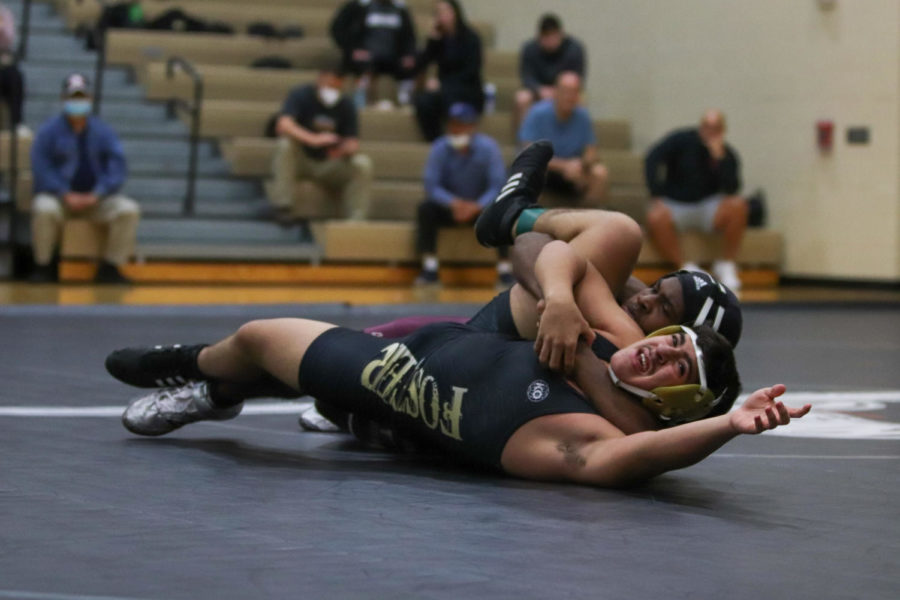 Cradle! Dylan Smith (11) getting a cradle on Foster's wrestler.