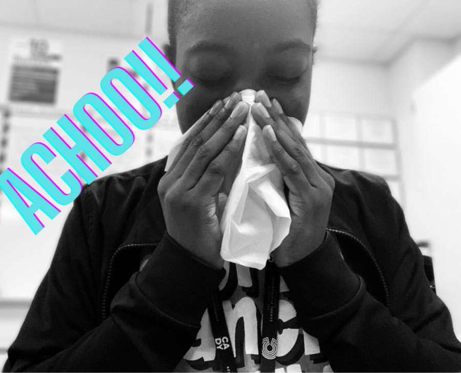 A person sneezing into a tissue.