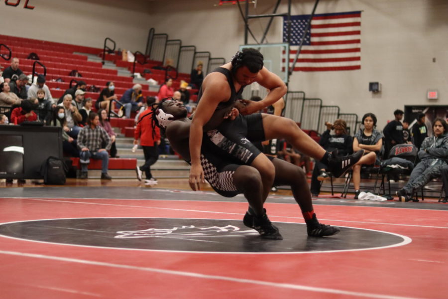 Donovan Bradfield (11) takes the plunge and attempts to throw his opponent. 