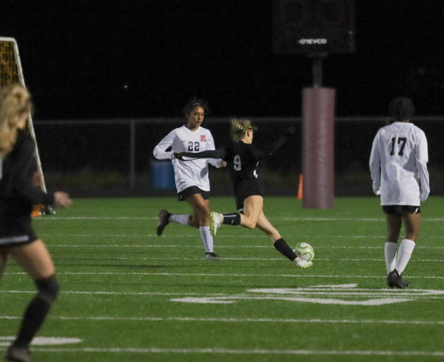 No. 9 Erica Phelan (12) about to launch the ball.