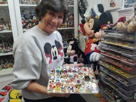 Mrs. Esteves showcasing her pin collection. Although only one tray is seen, she has over 1,400 pins.