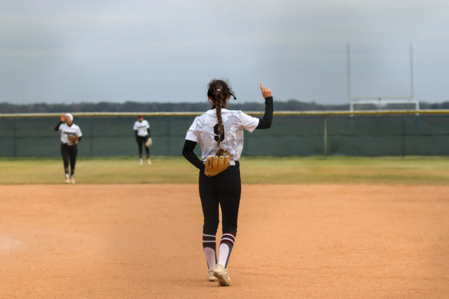 No. 9 Camryn Couvillion (12) telling her fellow teammates they have one out.