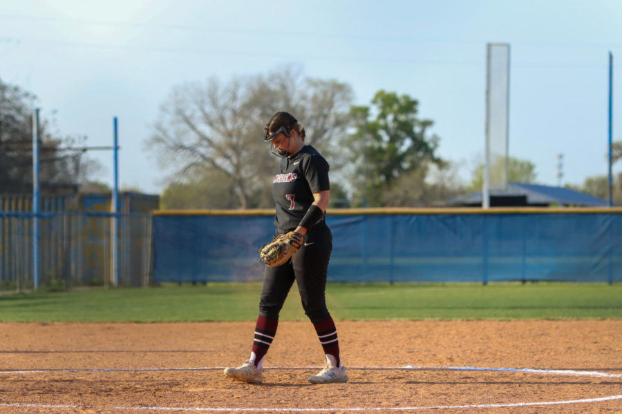 No. 7 Nora Thompson (12) walking up and preparing to pitch the ball.