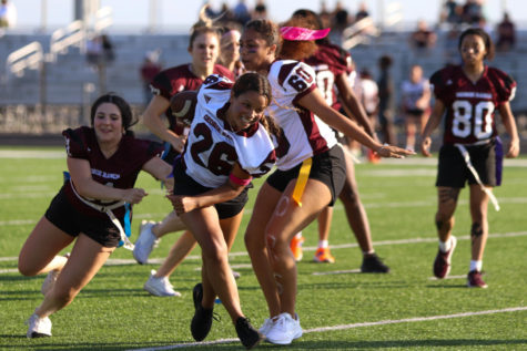 Larya Agston (12) hurdles through the opponents. 